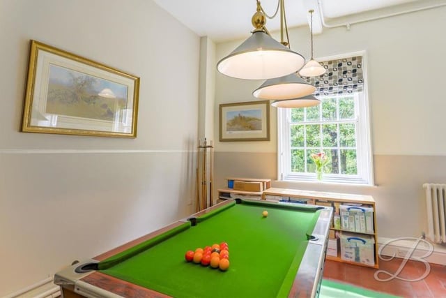 Making use of your leisure time is not a problem at the Crow Hill Drive property. You can while away the hours in this pool room, which has a feature fireplace and a window overlooking the front of the house.