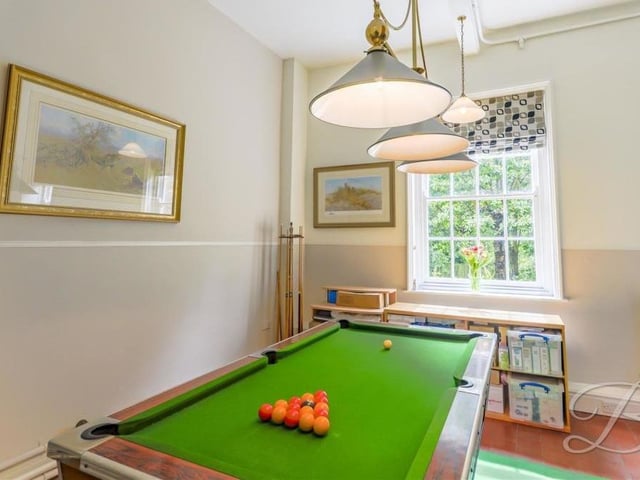 Making use of your leisure time is not a problem at the Crow Hill Drive property. You can while away the hours in this pool room, which has a feature fireplace and a window overlooking the front of the house.