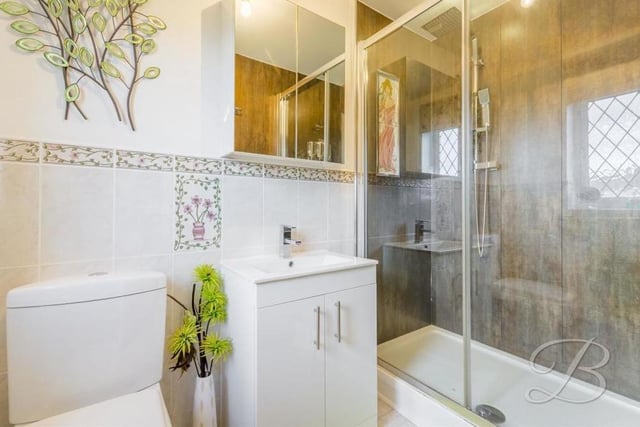 It's hard to fault the stylish en suite facilities attached to the master bedroom. They comprise a walk-in shower cubicle, a low-flush WC, and a hand wash basin with storage. An opaque window faces the back of the bungalow.