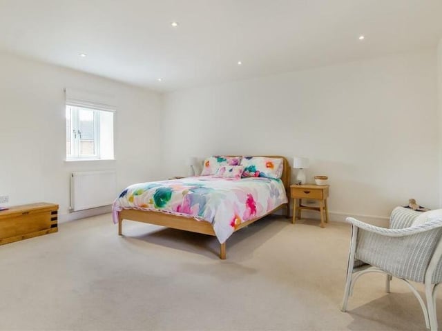 Into the bedrooms now at the £625,000 property, beginning with the spacious master. It boasts double-glazed windows to the front and back of the house, nine ceiling spotlights and a TV point.