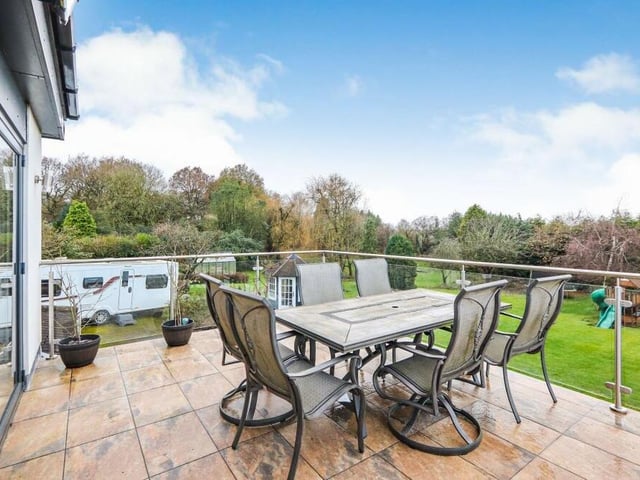 A snug, attached to the open-plan kitchen and dining area, has bi-folding doors that lead on to this fantastic balcony, which overlooks the gorgeous rear garden. It is an ideal spot for summer lunch.