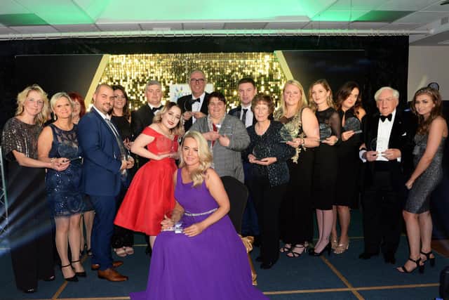 Past winners at the Chad’s Business & Community Excellence Awards celebrate with their trophies.