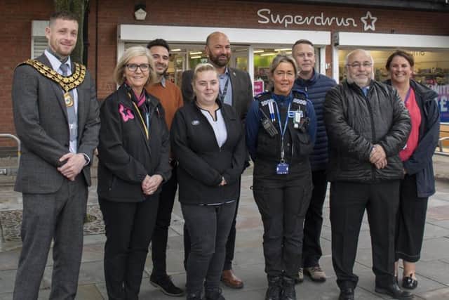 Coun Dale Grounds, Ashfield Council chairman, left, with Coun Andy Meakin, council officers, and shop workers in Kirkby. (Photo by: Ashfield Council)