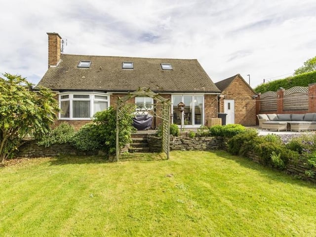 Let's step outside now and take in this shot of the pleasant surroundings at the back of the property. The lawned garden has mature planted borders, and you can just about spot the patio/seating area in the right-hand corner of the image.