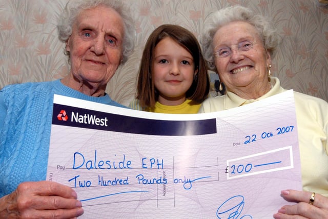Chloe Bacon representative of the 1st MWH Brownies and  the 2nd MWH Guides presented £200 to Joyce Tryner left and Gladys Rickers of the Daleside Centre Forest Town in 2007.