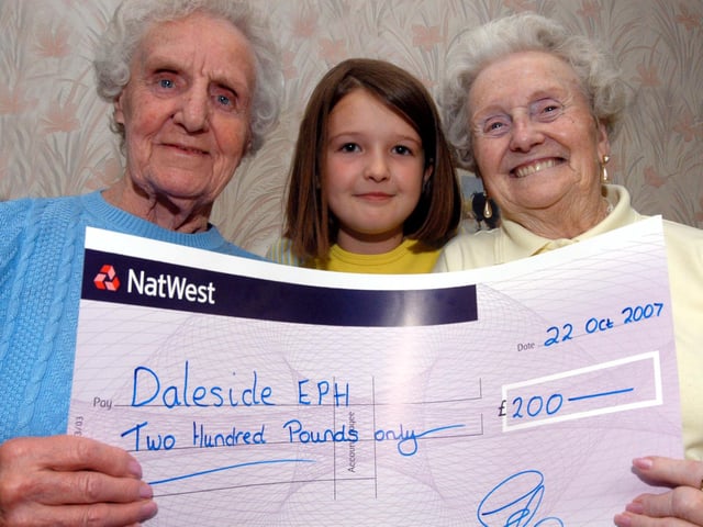 Chloe Bacon representative of the 1st MWH Brownies and  the 2nd MWH Guides presented £200 to Joyce Tryner left and Gladys Rickers of the Daleside Centre Forest Town in 2007.