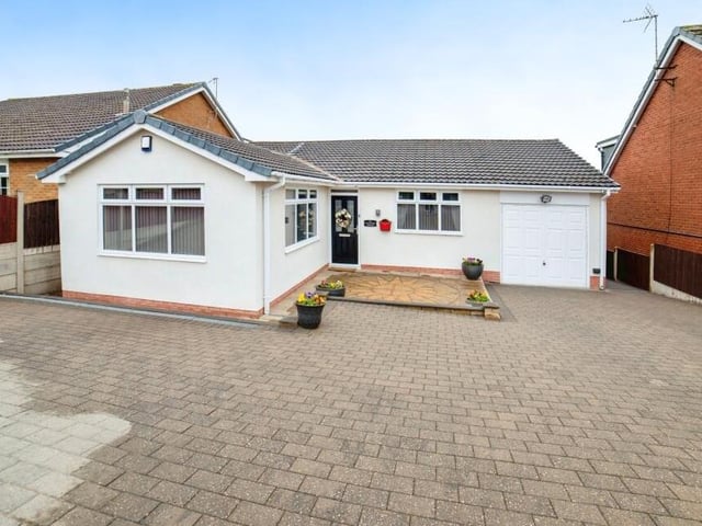 We close our gallery by returning to the front of the £300,000 bungalow, where a block-paved driveway provides off-street parking space and leads to a handy garage.