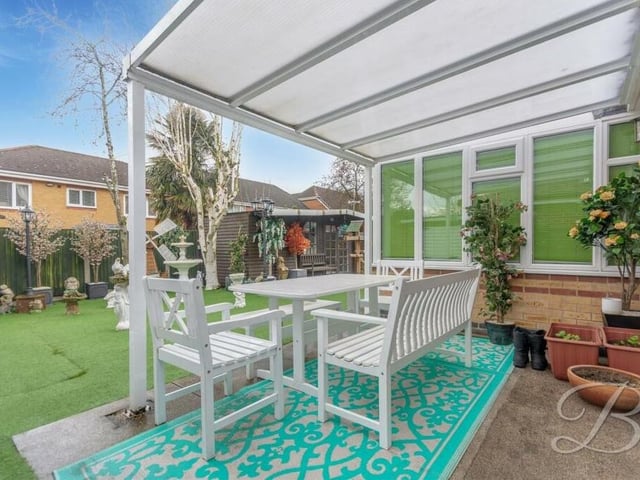 The back garden includes this lovely, covered seating area, which is an ideal spot to relax during the spring and summer.