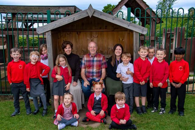 Adults left to right are Joanna Redfern, executive headteacher, David Mills, chair of Governors, and Kathryn Woods, acting headteacher, with children of All Saints’ C of E Infant & Nursery School