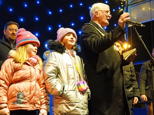 Ashfield Council chairman Arnie Hankin switches the lights on with help.