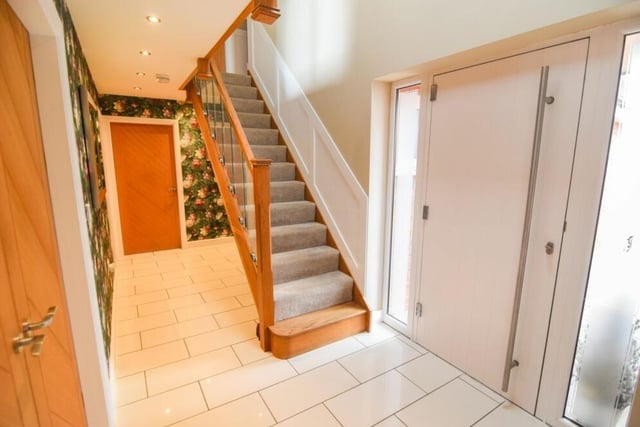 Back into the entrance hall now as we prepare to go upstairs to see the five bedrooms. At the top of the staircase is a landing with a fitted oak banister and glass panels.