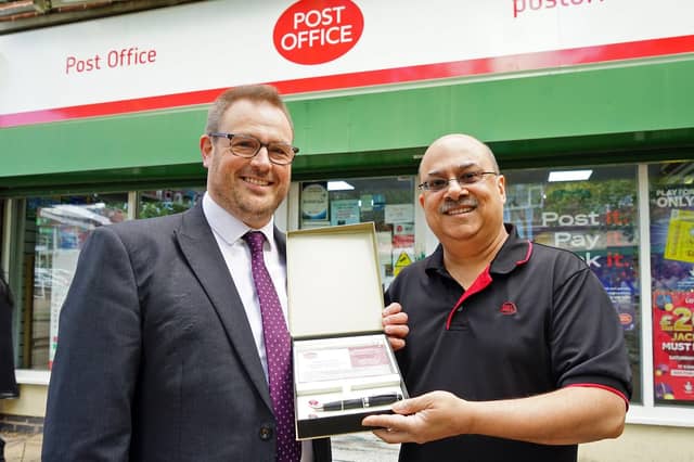 Kalpesh Bhatt, the postmaster from Ladybrook, celebrates his 60th birthday and over 20 years of service at the post office. Pictured: Gideon Hancock with Kalpesh.