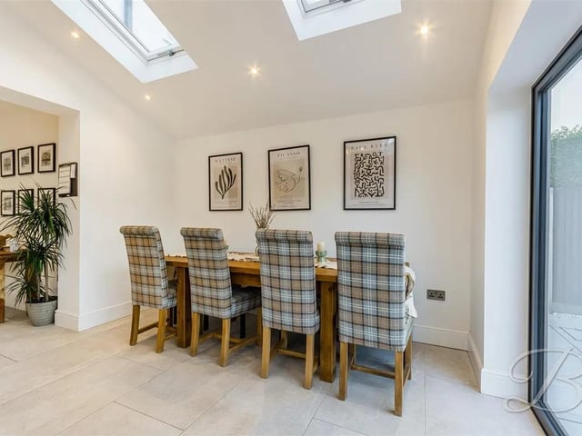 The kitchen opens onto a large family dining area, perfect for entertaining.