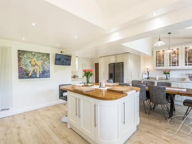 he heart of the room offers a centre island, creating a wonderful space for both cooking and socialising. The dining area boasts space for a set of sleek table and chairs to enjoy sit down meals with family and friends.