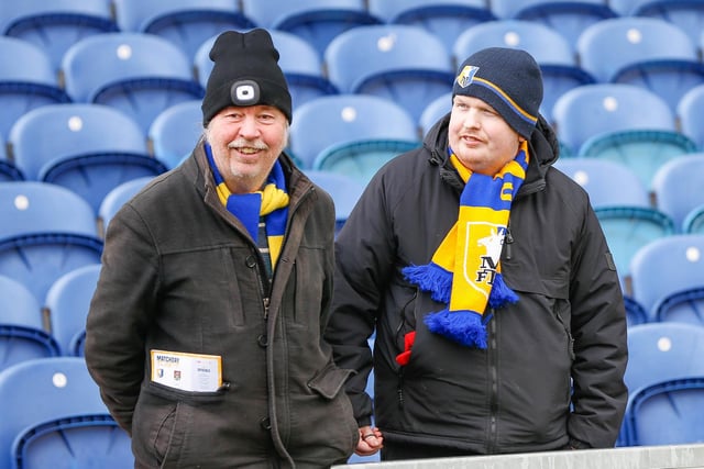Mansfield Town fans watch the match against Northampton Town.
