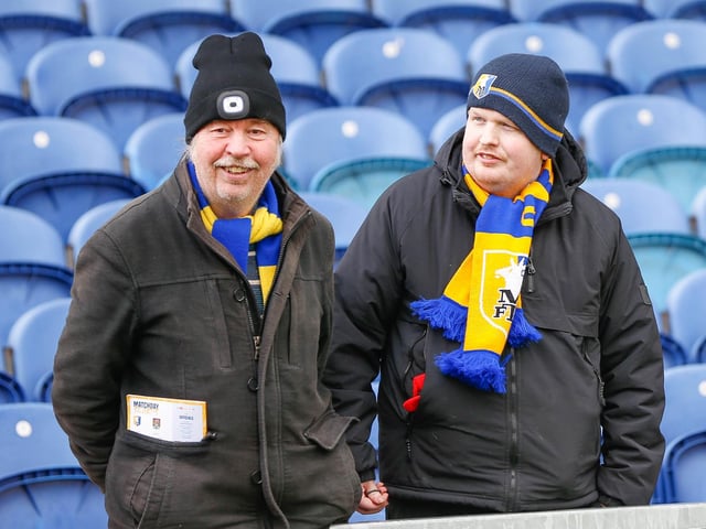 Mansfield Town fans watch the match against Northampton Town.