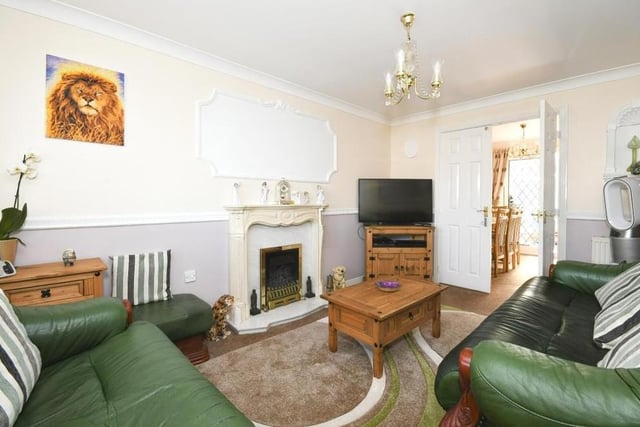 From the entrance hall, you are immediately directed to this pleasant living room or lounge. It has a feature fireplace and also a bay-fronted window overlooking the front of the property.