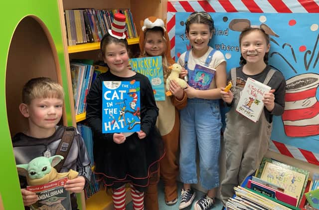 A group of friends at Kimberley Primary and Nursery School are pictured holding books in the school library.