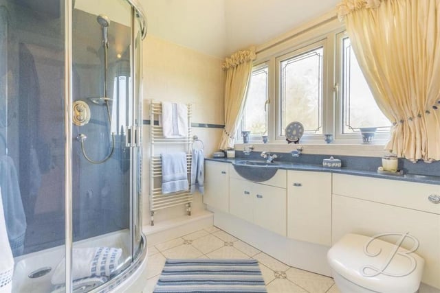 Four of the six upstairs bedrooms at the £1.2 million house boast their own en suite facilities. This elegant example belongs to the biggest bedroom. It comes complete with an enclosed shower, wash hand basin, low-flush WC, vanity unit, heated towel-rail and tiled flooring.