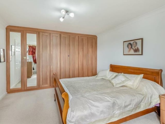 All four first-floor bedrooms are a good size, particularly the master, which boasts extensive fitted wardrobes, complete with hanging rails and shelves, plus access to boarded eaves storage. Its window overlooks the back of the property.