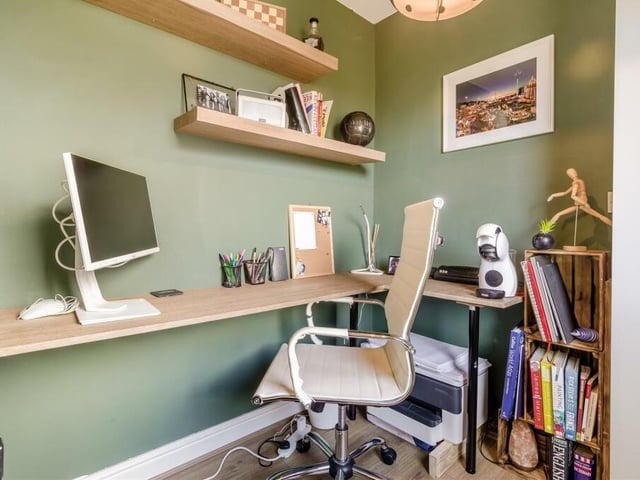 Close to the four bedrooms is this handy office. It includes a fitted L-shaped desk, laminate floor and uPVC door leading outside.