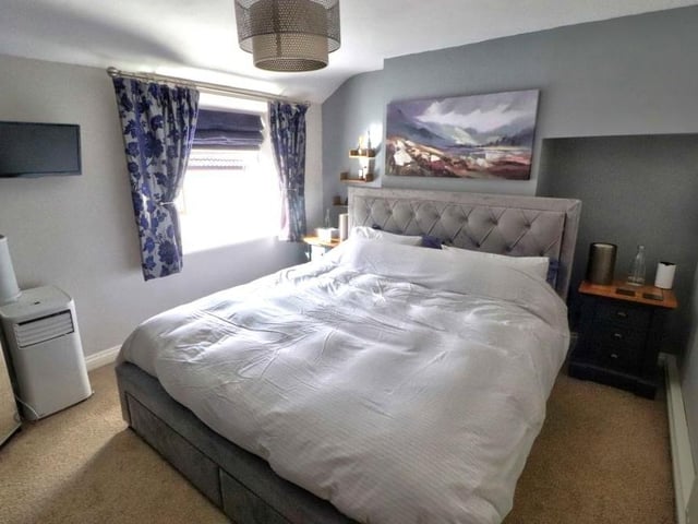 Let's move upstairs now and take a look at the main bedroom, which faces the front of the £200,000 Kirkby cottage. It is bright and a good size, with a carpeted floor.