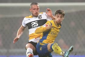 Lewis Brunt of Mansfield Town is challenged by Ryan Loft of Port Vale during the Carabao Cup Fourth Round match between Mansfield Town and Port Vale at Field Mill on October 31, 2023 in Mansfield, England. (Photo by Cameron Smith/Getty Images)