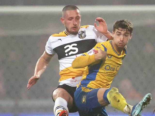 Lewis Brunt of Mansfield Town is challenged by Ryan Loft of Port Vale during the Carabao Cup Fourth Round match between Mansfield Town and Port Vale at Field Mill on October 31, 2023 in Mansfield, England. (Photo by Cameron Smith/Getty Images)