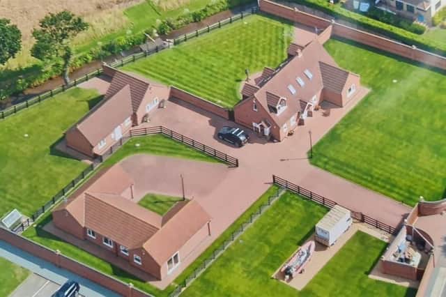 A spectacular aerial shot of the property at Moor Lane, Calverton, which comprises a four-bedroom home, two detached bungalows and substantial land. It is on the market for £1,650,000.