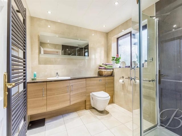 The en suite features a three piece suite comprising of a hand wash basin, low flush WC and a shower.