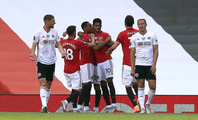 Manchester United's Anthony Martial celebrates scoring his side's first goal of the game with Marcus Rashford as Sheffield United's Chris Basham (left) speaks to team-mate Phil Jagielka during the Premier League match at Old Trafford