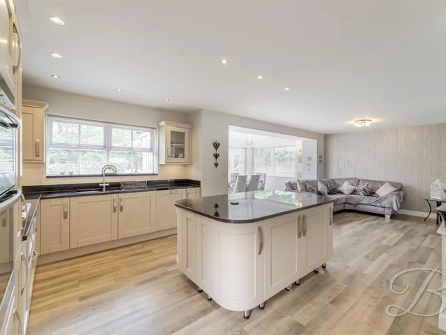 The welcoming entrance hall leads you to the heart of the home-a spectacular open-plan kitchen, dining, and living space designed for everyday living and entertaining. The kitchen features a central island and ample work surfaces, providing a perfect hub for family meals and social gatherings. Natural light floods the dining and living areas, which seamlessly connect and open directly onto the garden, creating a bright, airy, and inviting atmosphere.