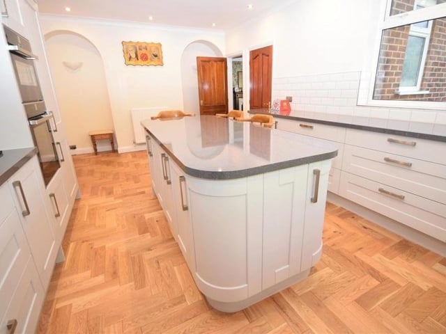 The breakfast kitchen boasts a feature centre island and breakfast bar, which is the ideal space for informal meals with the family. There is also a useful walk-in pantry for extra storage, while the room enjoys a relaxed ambience thanks to its atmospheric downlighting.