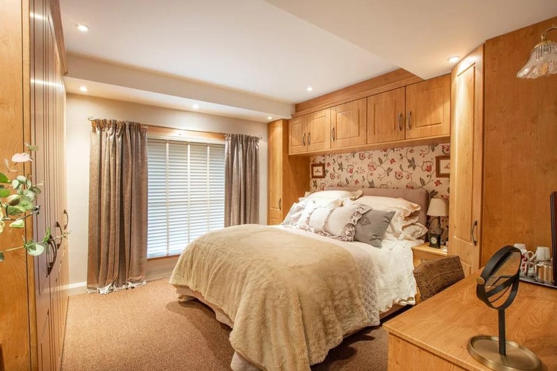 The master bedroom - with an adjoining en-suite - faces to the front of the building. It has extensive fitted wardrobes featuring hanging space and a vanity unit.