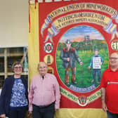 Museum volunteers Ann and Barry Donlan, David Whitchurch and Dennis Burgin with the NUM Ex and Retired Mineworkers Banner.