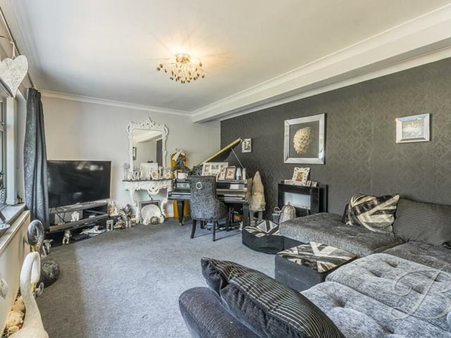As well as the sitting room, the Mansfield house also boasts this separate and homely living room, which has a carpeted floor and a window overlooking the front of the property.
