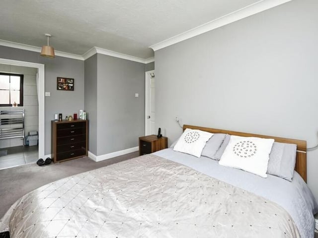 Let's move upstairs, where you will find all five bedrooms, including this large master. It is described by estate agents Purplebricks as "a serene heaven" and has access to an en suite.