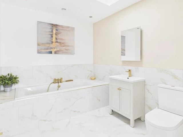 Another highlight of this home is the beautiful and luxurious principal en-suite bathroom with a perfect balance of modern and traditional. Large double-ended bath with gold-effect mixer taps and a hand-held shower with vanity basin with gold-effect taps and bathroom storage. Carrera gold-effect marble tiling. Gold-effect towel radiator and skylight.