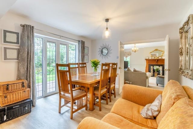 The dining table in the living space has pleasant views of the south-facing rear garden, which can also be accessed via French doors.