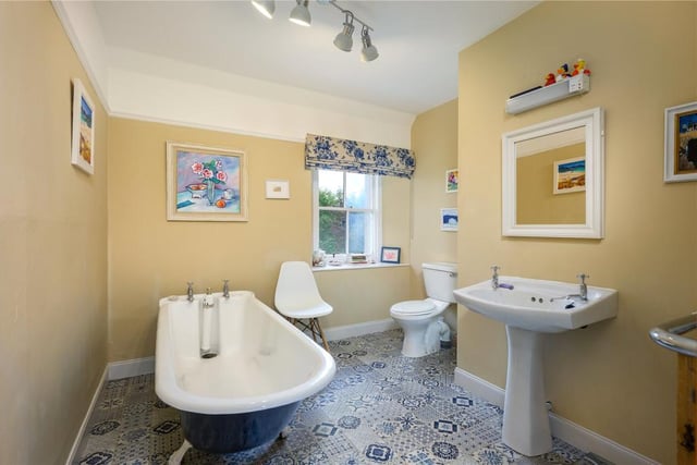 The bathroom includes a free standing bath.