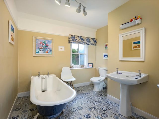 The bathroom includes a free standing bath.