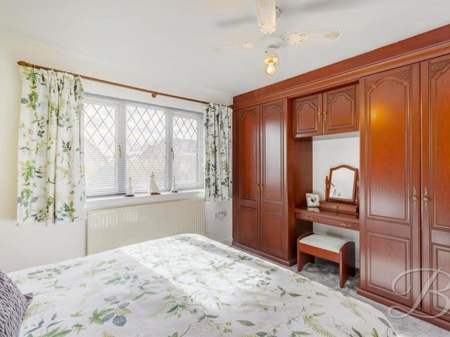 The second, third and fourth bedrooms are all of a similar size and kept to a very high standard. This one overlooks the front of the Holly Drive bungalow and includes fitted wardrobes, a carpeted floor and a central heating radiator.