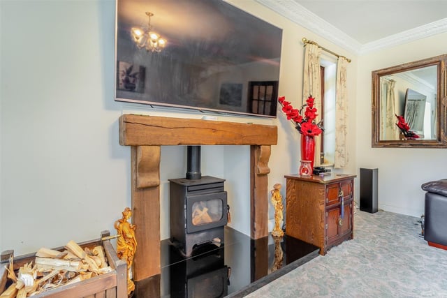 A star feature of the lounge is this oak-style fireplace with inset log-burner, mounted on a large granite hearth.