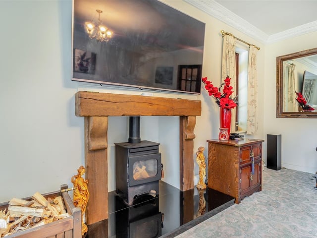 A star feature of the lounge is this oak-style fireplace with inset log-burner, mounted on a large granite hearth.