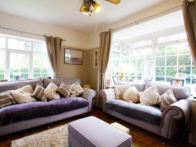 The first reception room in the house is cosy and spacious. It has a double-glazed bay window to the front and a double-glazed window to the side, plus wood flooring.
