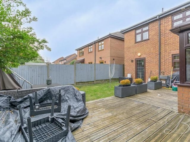 A decking area, with space for seating, in the back garden lends itself to summer barbecues with friends.