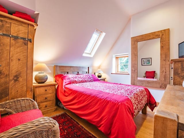 Here is the third double bedroom on the first floor. It comfortably accommodates a king-sized bed and a range of furniture pieces.