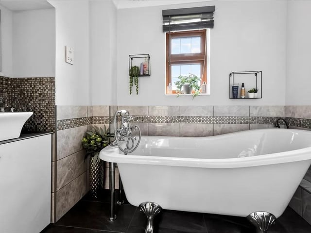 The well-appointed family bathroom has a freestanding claw foot bath, perfect for unwinding after a busy day.