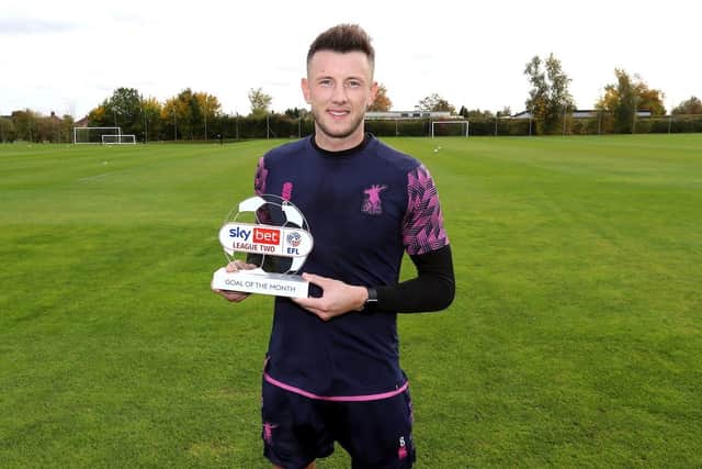 Ollie Clarke with his Goal of the Month trophy.