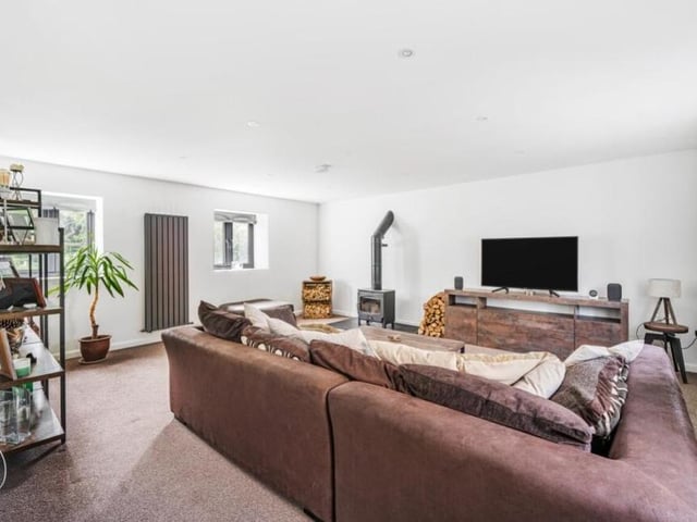 The living room offers a warm retreat on chilly evenings, thanks largely to its centrepiece, which is a wood-burning stove.